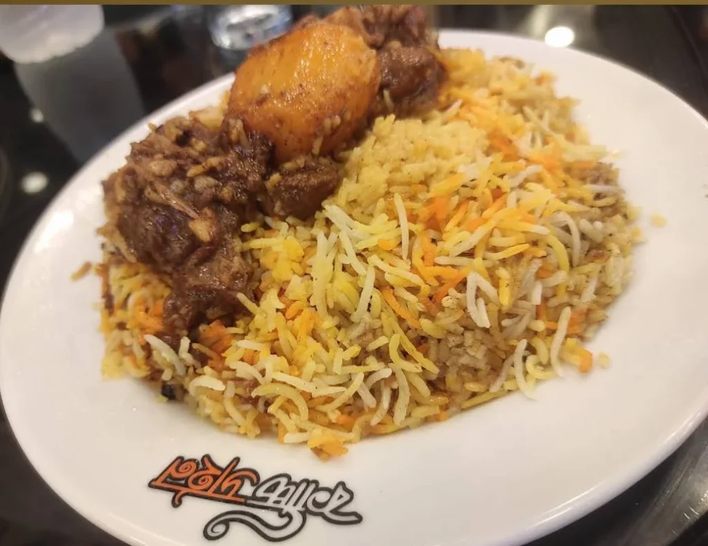 Fluffy basmati rice with tender mutton pieces, cooked with aromatic spices and served with a rich gravy in a traditional Mutton Kacchi.